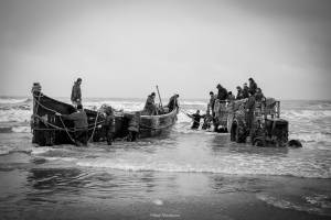 ماهیگیران در حال انتقال تور و لنج به آب
